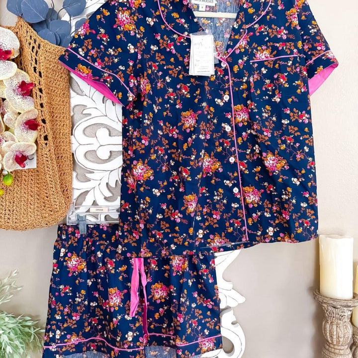 Chic Collective navy blue floral print pajama set with pink trim. Short sleeve top and shorts.
