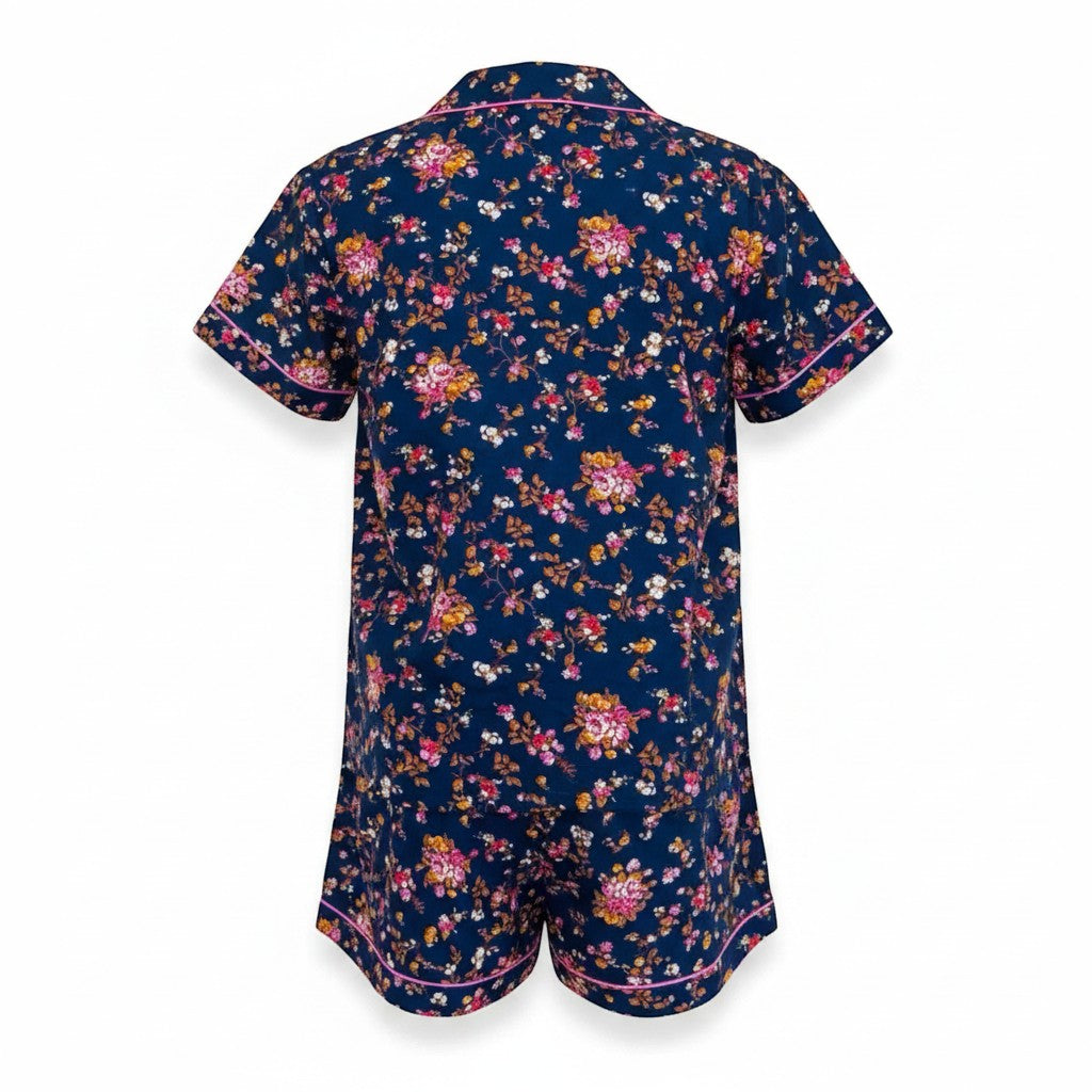 Chic Collective navy blue floral print short pajama set with pink trim. Short sleeves, collared neckline, and shorts.