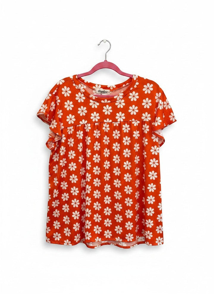 Chic Collective orange babydoll top with white daisy print and flutter sleeves.