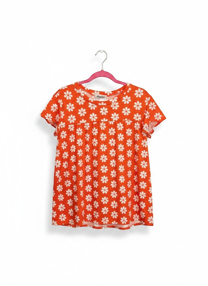 Chic Collective orange babydoll top with white daisy print and flutter sleeves. Soft, breathable fabric.