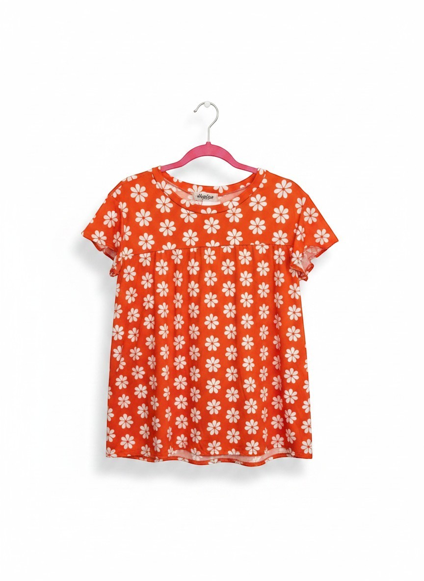 Chic Collective orange babydoll top with white daisy print and flutter sleeves.