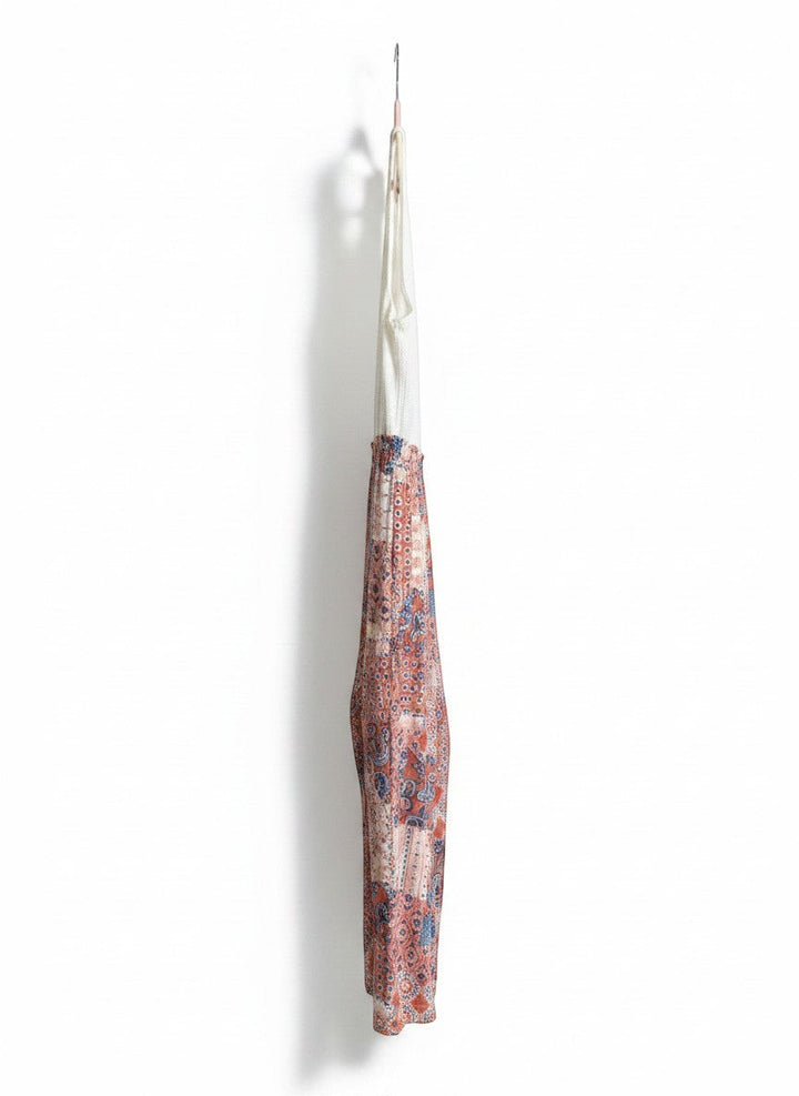 Chic Collective ivory coral vintage patchwork knit jumpsuit with a white ribbed top and patterned wide legs.