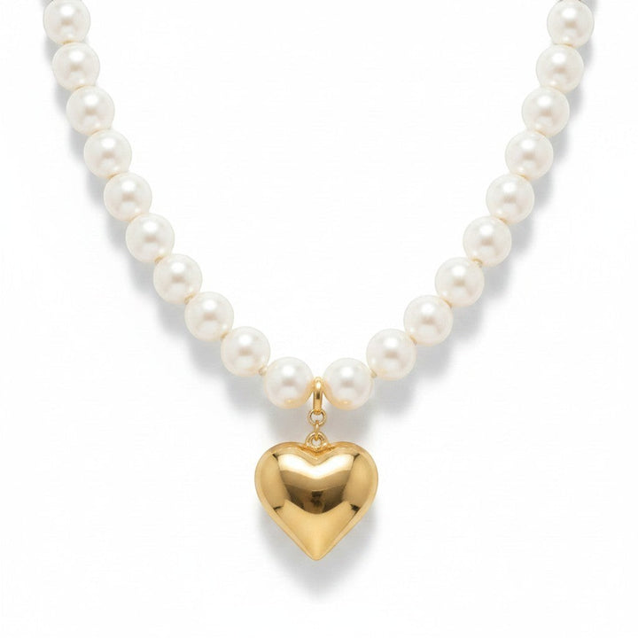 Chic Collective white pearl necklace with a gold-tone heart charm pendant.
