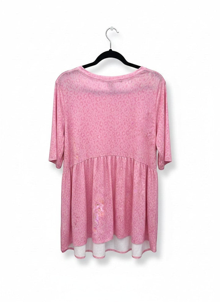 Chic Collective soft pink animal print babydoll top with short sleeves and a tiered hem.