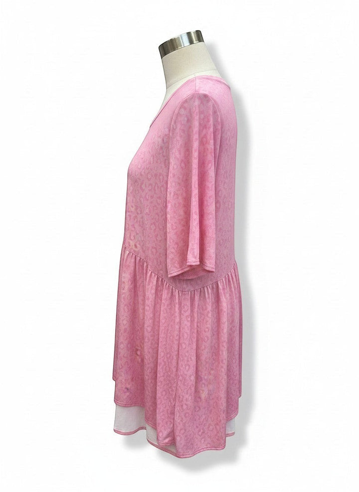 Chic Collective soft pink babydoll top with an all-over subtle animal print and a tiered hem.