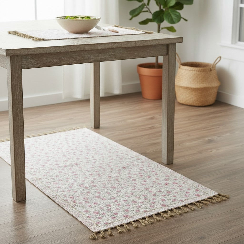Chic Collective pink floral cotton and chenille rug with tassels and coordinating border, watercolor style.