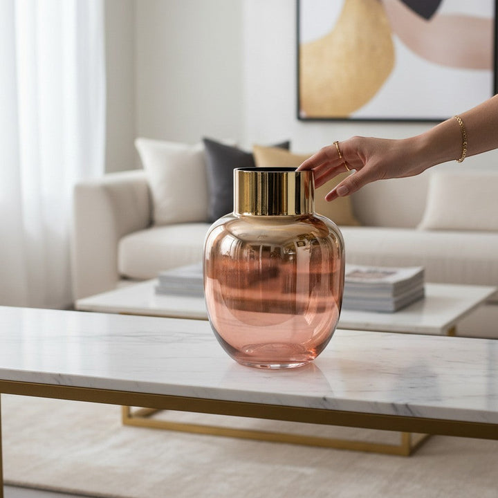 Chic Collective pink and gold metallic glass vase with ribbed gold neck, displayed on a marble coffee table.