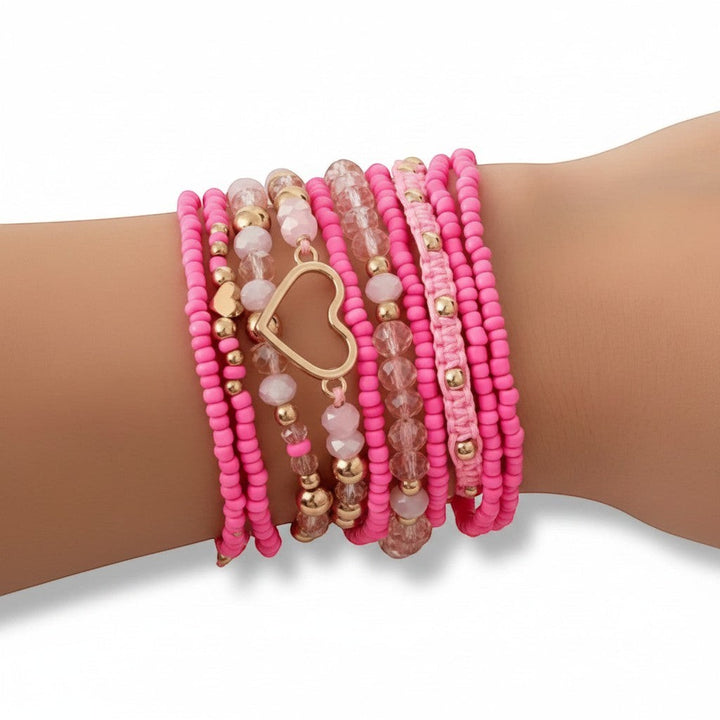 Chic Collective Pink Heart Stack bracelets with pink beads, gold accents, and clear pink crystals. Features a gold heart charm.