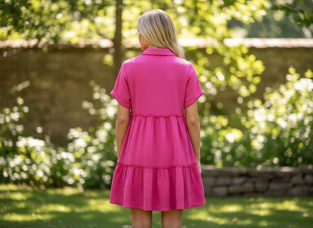 Chic Collective pink mineral wash tiered mini dress with short sleeves and collar, worn by a woman outdoors.