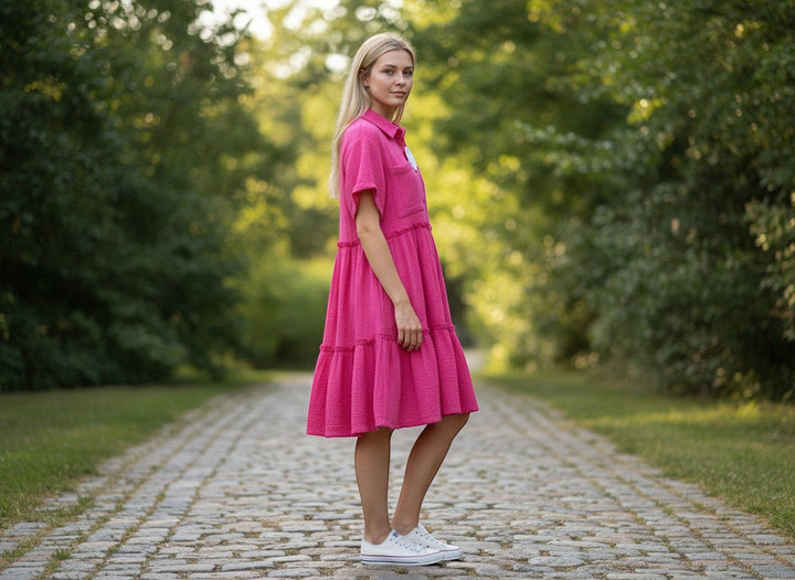 Chic Collective pink mineral wash tiered midi dress with short sleeves and collar, worn by a woman outdoors.