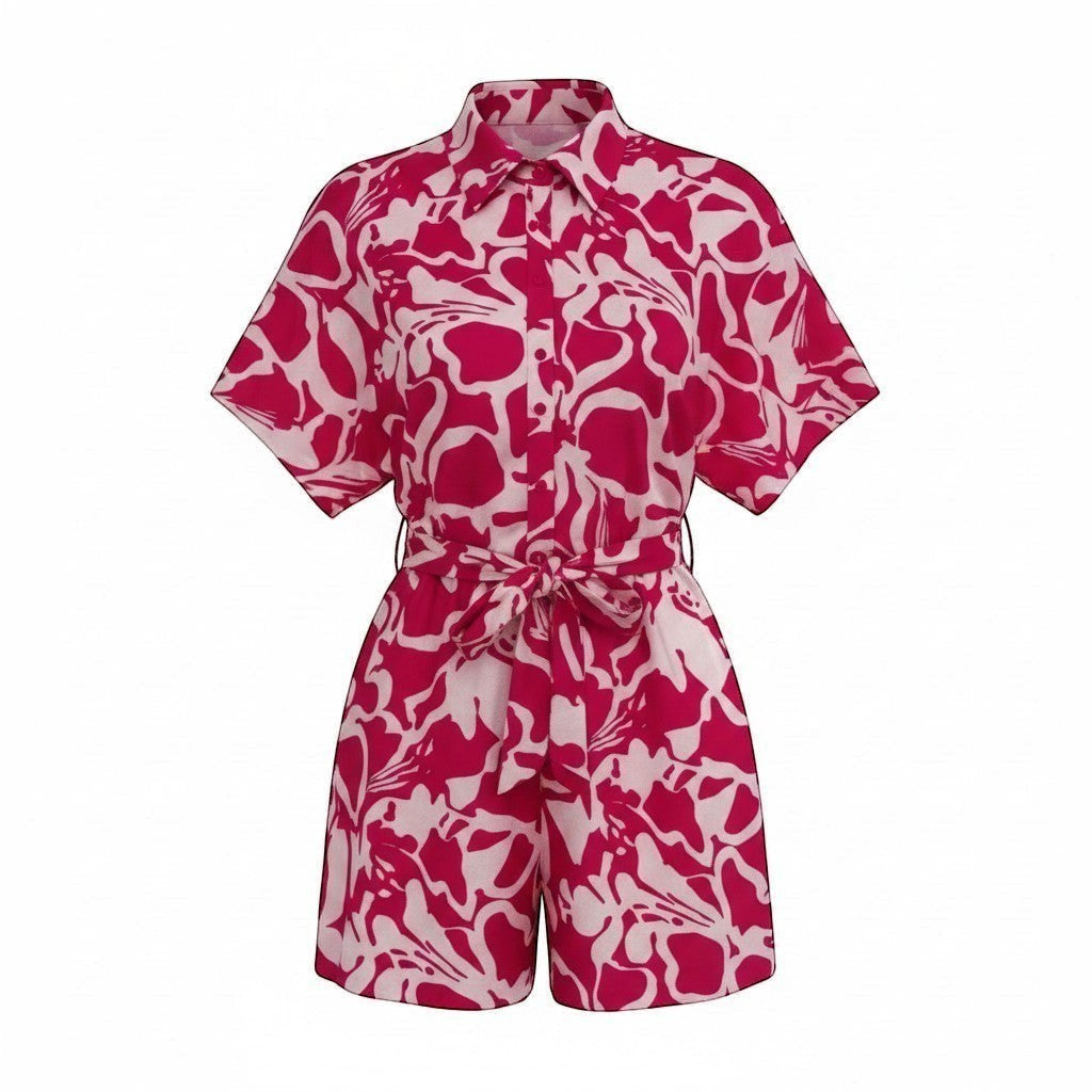 Chic Collective pink and white floral print short jumpsuit with short sleeves, collar, and tie waist.