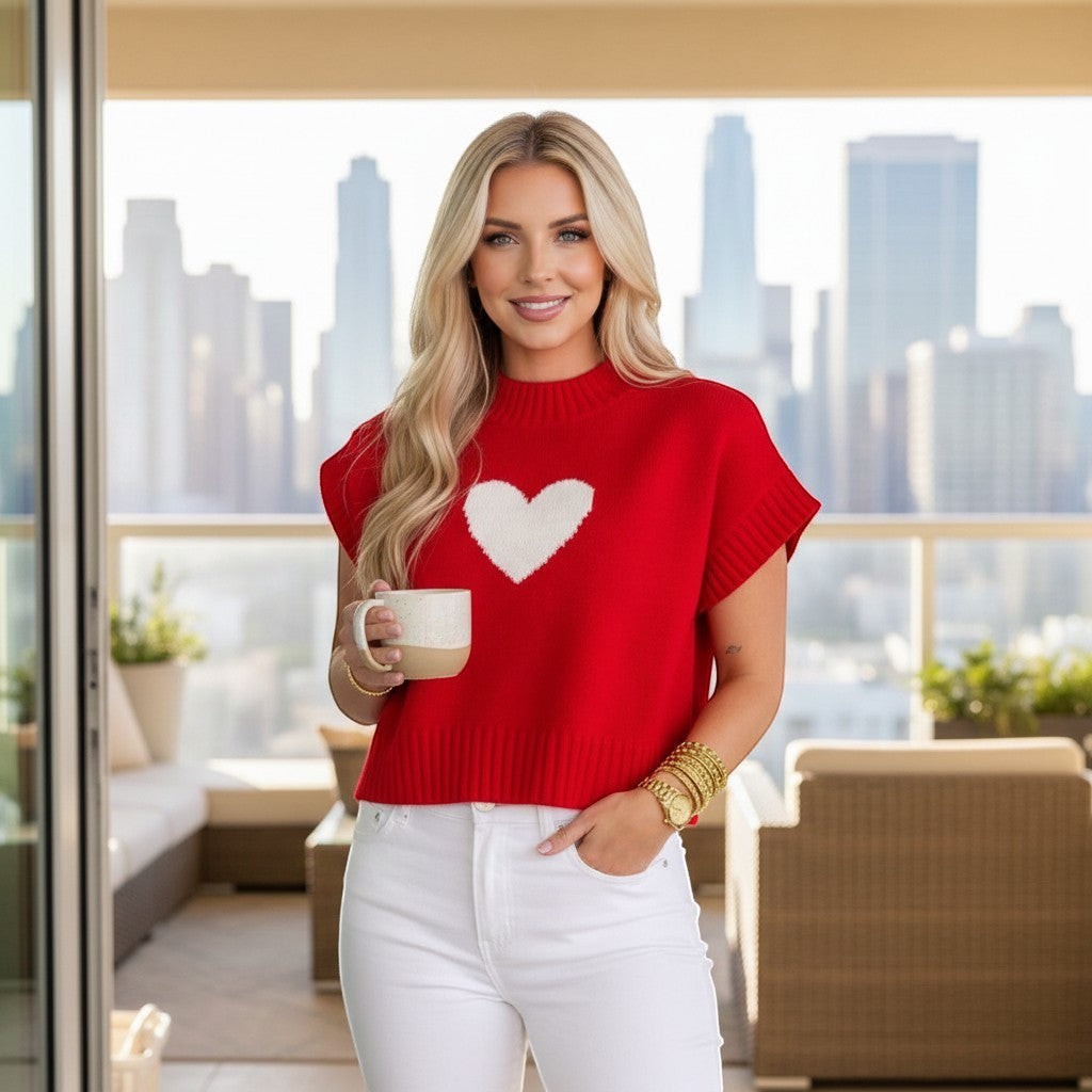 Chic Collective red knit sweater with white heart detail, short sleeves, crew neck, size S. Model holds mug.