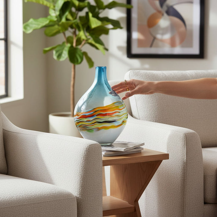 Chic Collective Rhian hand-blown glass vase with blue top and painterly waves of orange, yellow, and white.