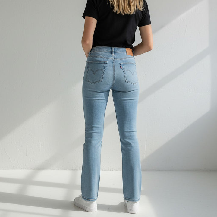 Chic Collective Risen Mid Rise Frayed light wash denim jeans with a slight flare and frayed hem. Model wears size 13.