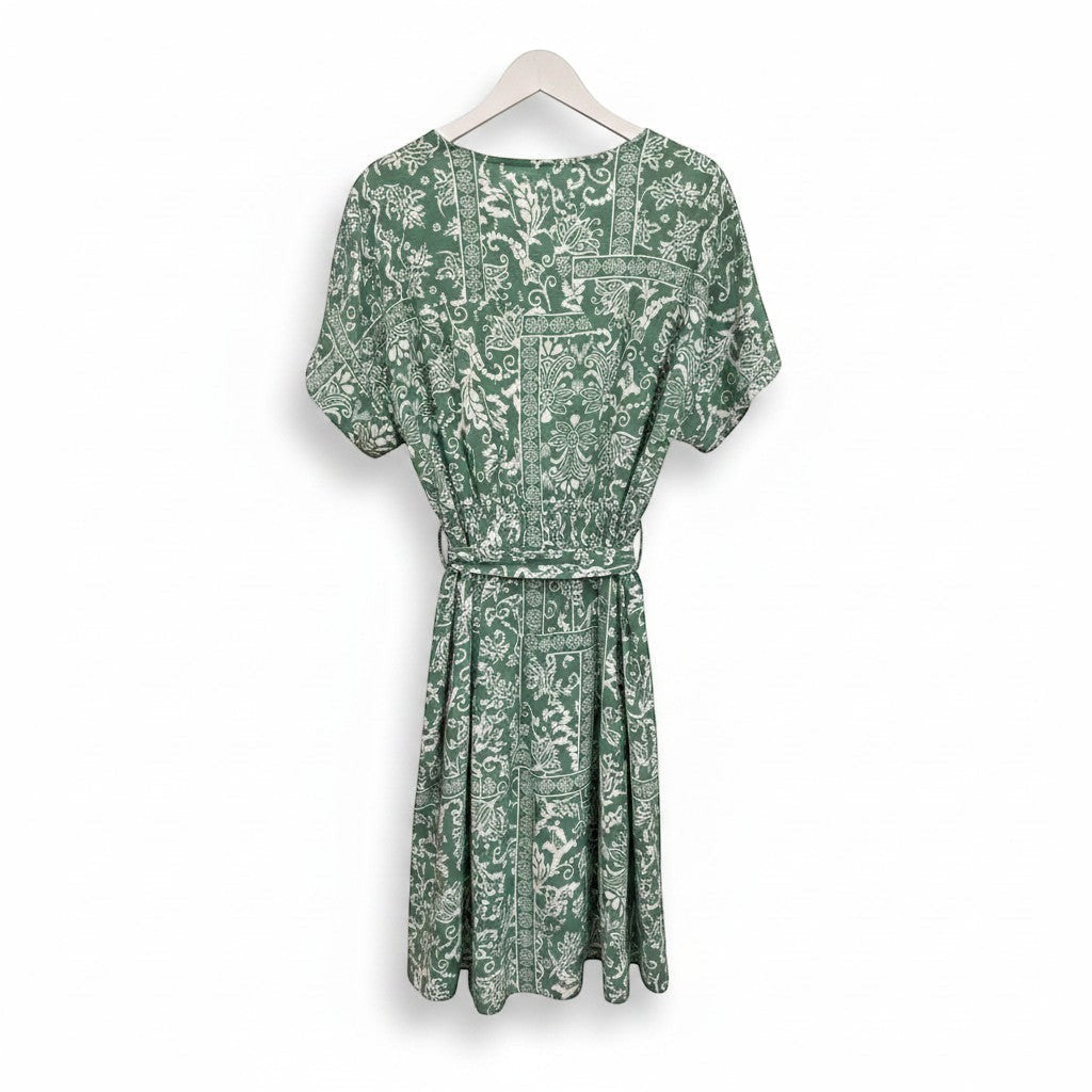 Chic Collective sage green boho surplice romper with short sleeves, wrap-style bodice, elasticated waist, and tie belt. Features a white paisley and geometric print.
