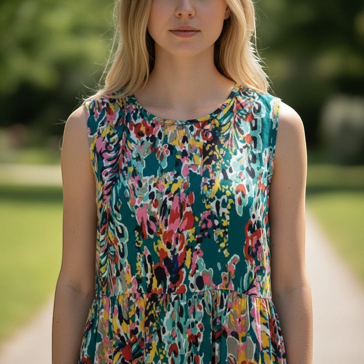 Chic Collective teal tiered sleeveless maxi dress with a vibrant abstract floral print and flowing silhouette.