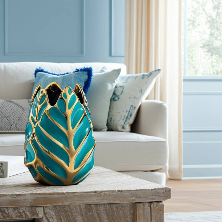 Chic Collective teal and gold leaf-shaped stoneware vase with glossy finish, 8 inches tall.