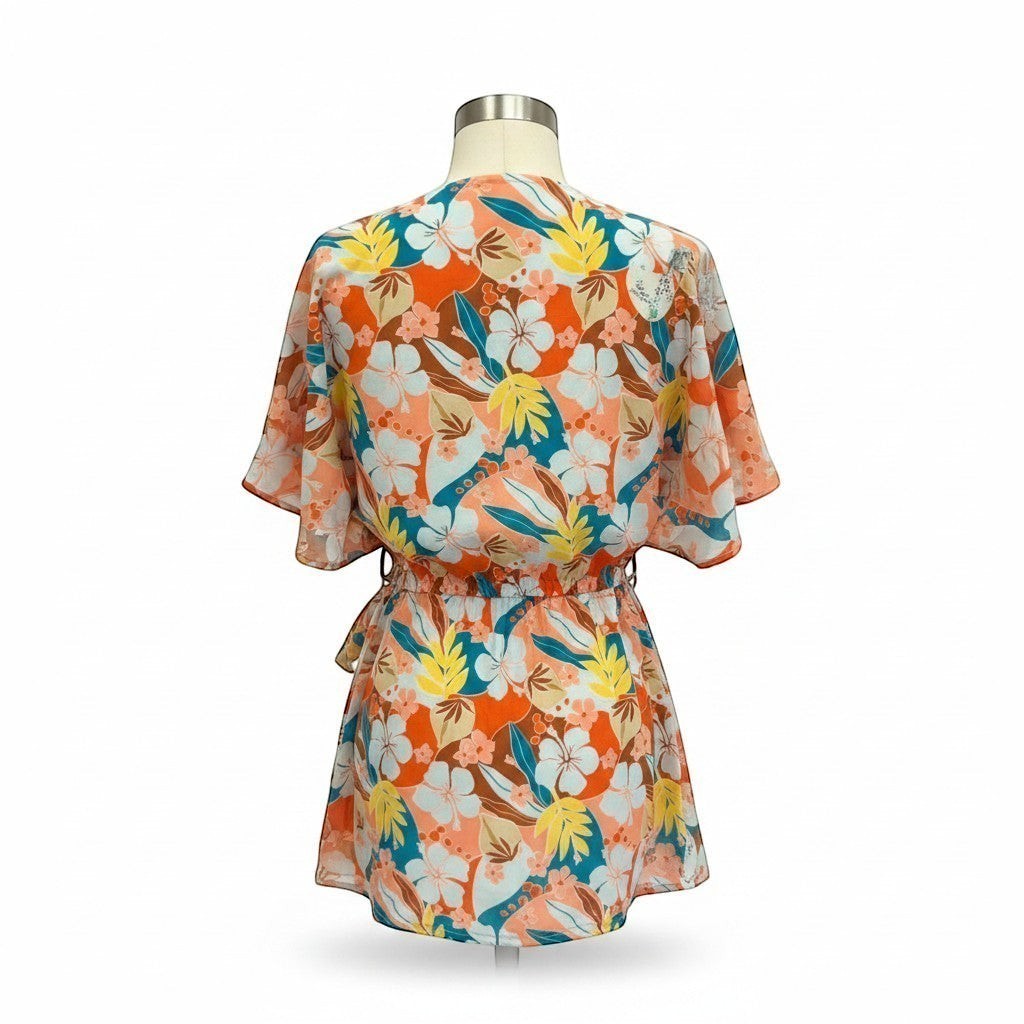 Chic Collective tropical print dolman sleeve romper with flared shorts and cinched waist. Orange, teal, yellow, and white floral pattern.