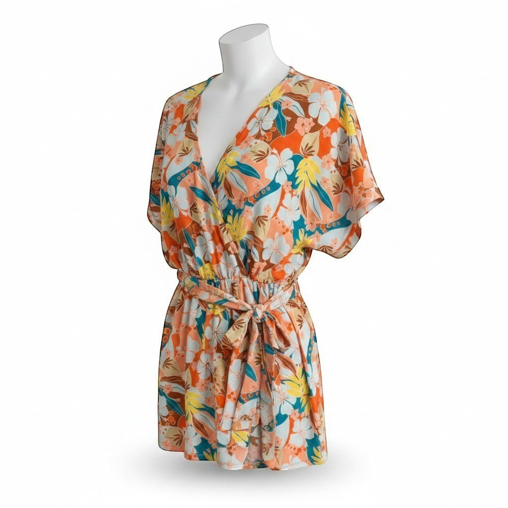 Chic Collective orange, blue, and yellow floral print dolman sleeve romper with surplice neckline and tie waist.
