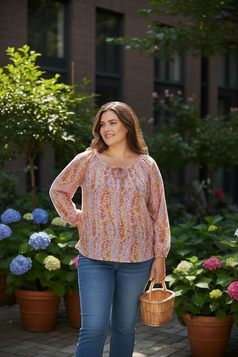 Chic Collective watercolor floral print blouse with keyhole front tie, long sleeves, and a relaxed fit, worn by a model outdoors.