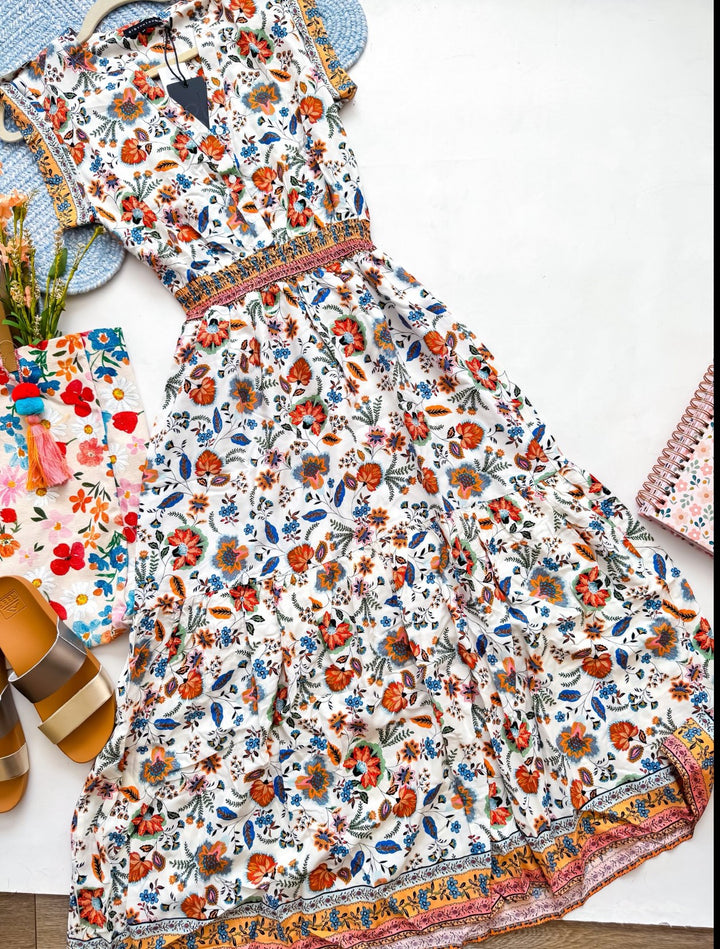 Chic Collective white maxi dress with a vibrant floral paisley print, V-neck, elasticated waist, and tiered skirt.