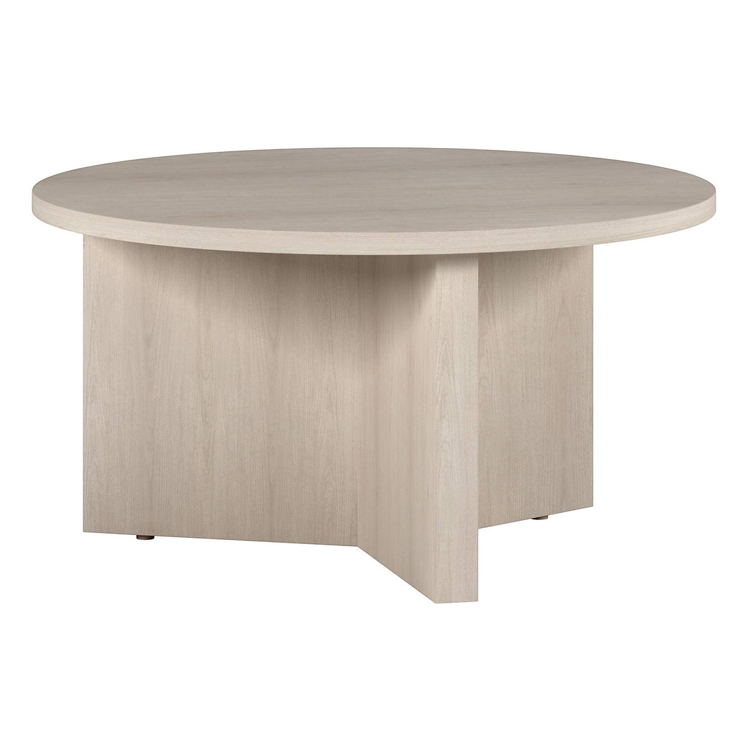Chic Collective modern white round coffee table made of manufactured wood with a minimalist design and sturdy pedestal base.