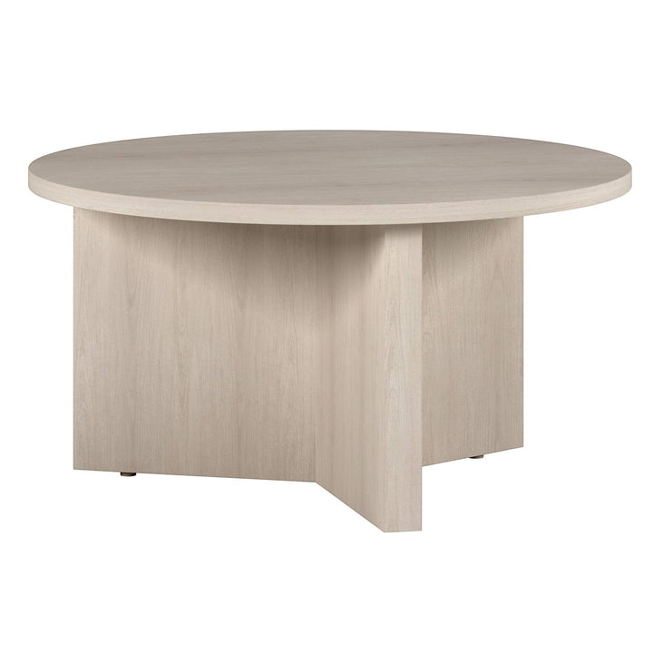 Chic Collective modern white round coffee table made of manufactured wood with a minimalist design and sturdy pedestal base.