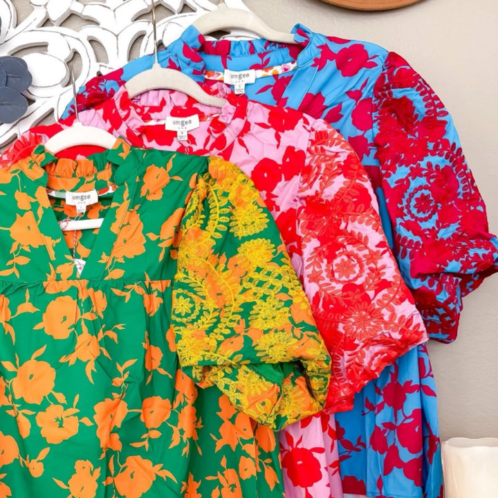 Chic Collective embroidered tops in green with orange floral print, pink with red floral print, and blue with red floral print.