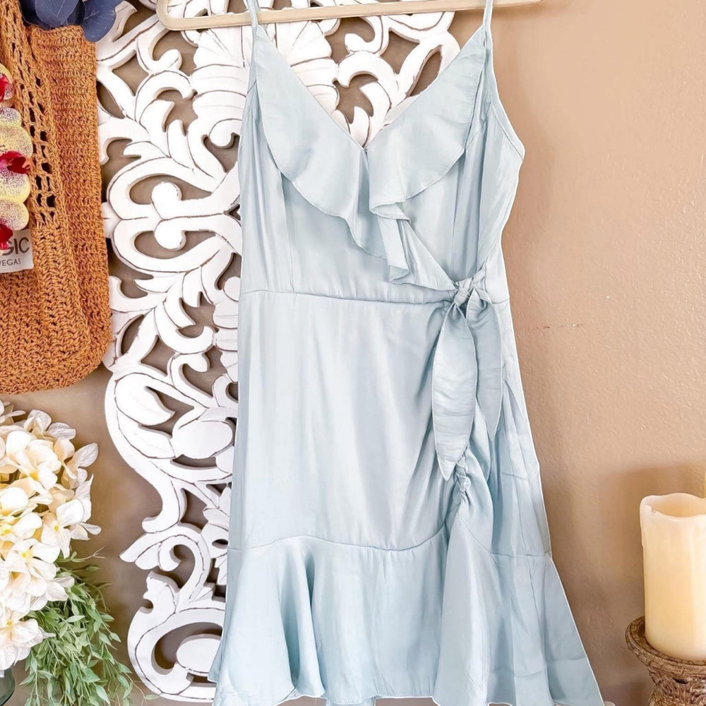 Chic Collective light blue wrap dress with ruffle trim and tie waist. Lightweight fabric, spaghetti straps, and a flattering silhouette.