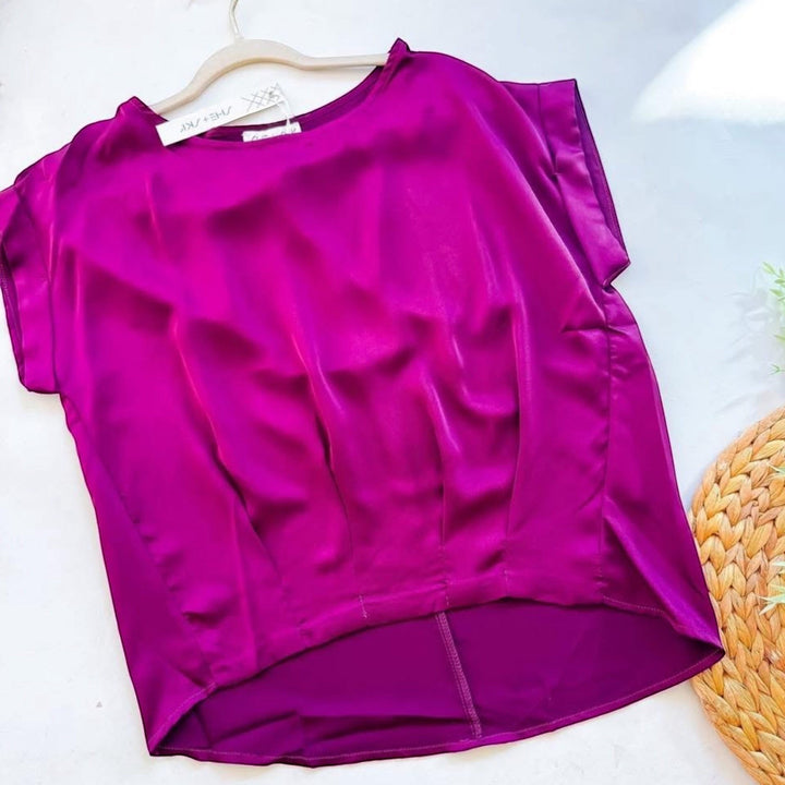Chic Collective plum satin short sleeve top with a flattering fit and a high-low hemline.